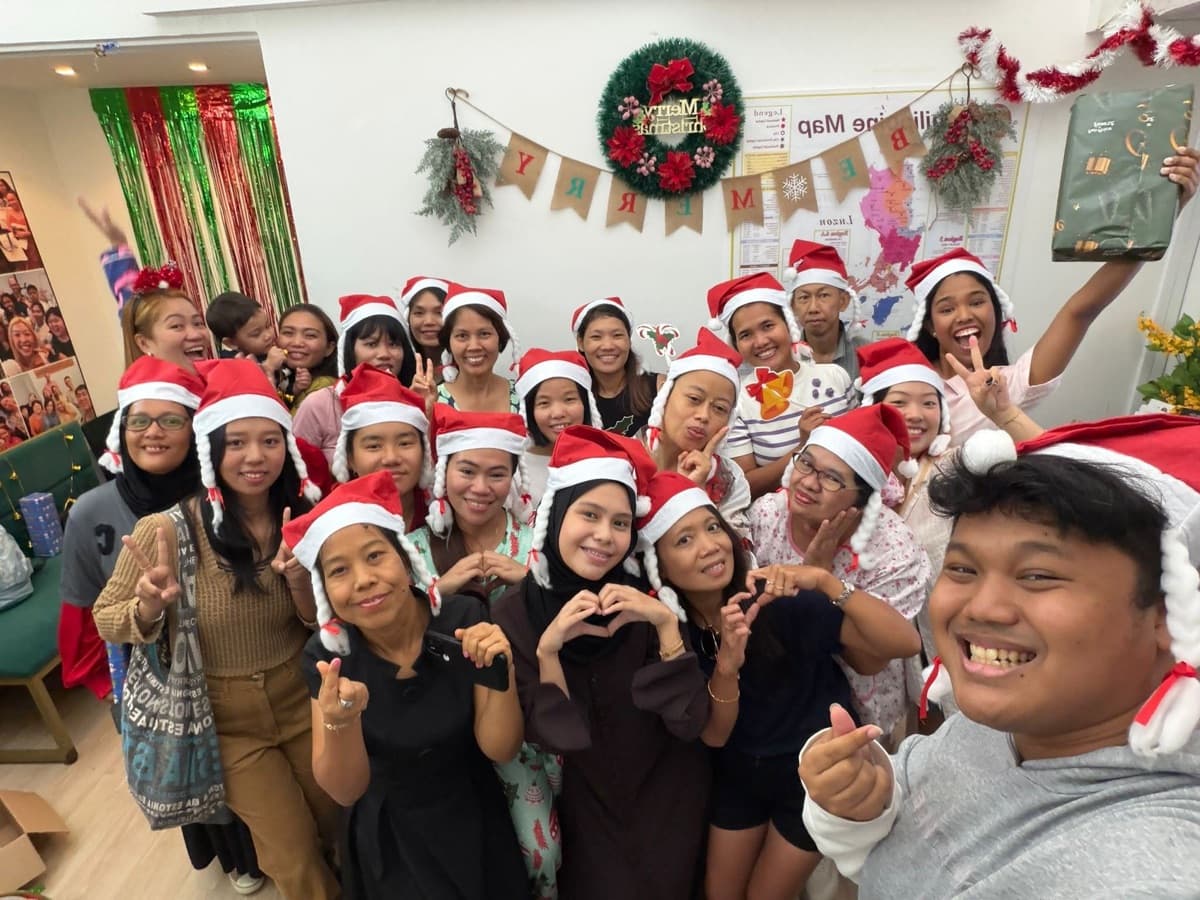 Helpers in Santa hats at the Christmas party in the office