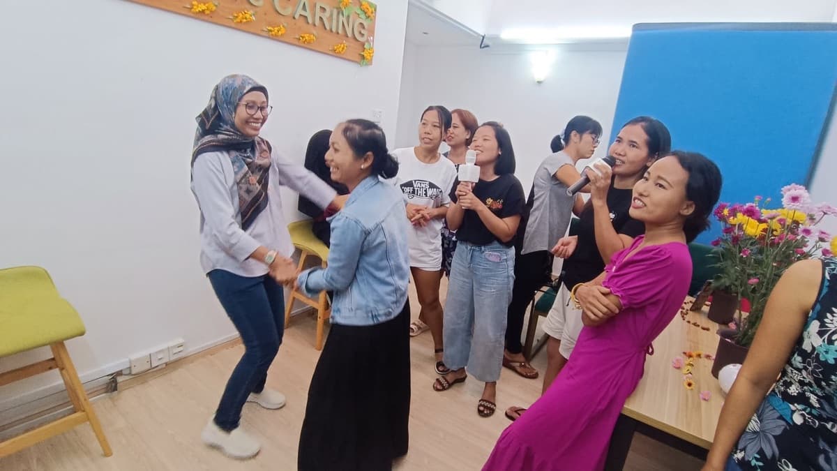 Helpers dancing at a community celebration