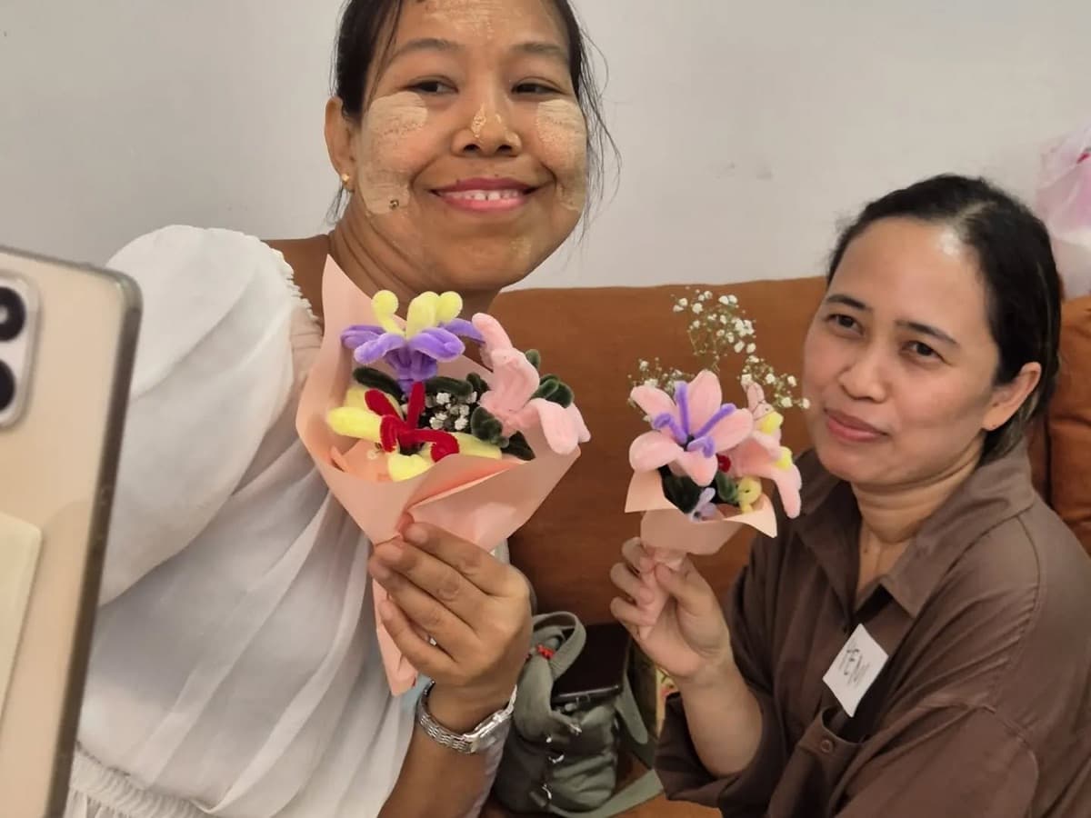 Helpers holding the bouquets they made at a flower workshop