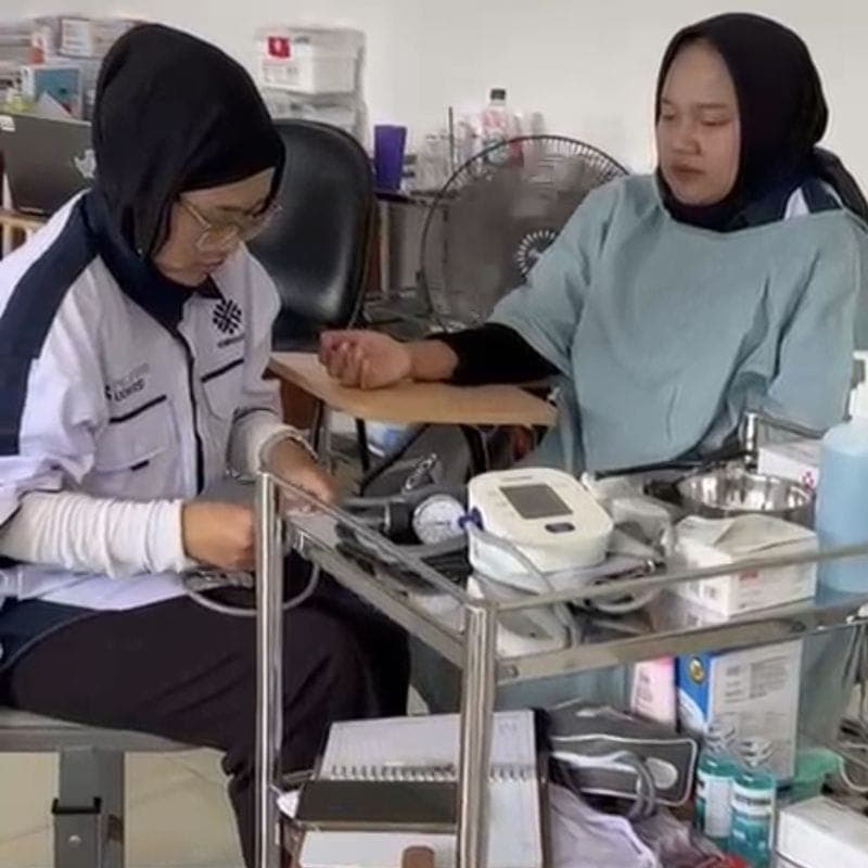 A trainee caregiver measuring blood pressure