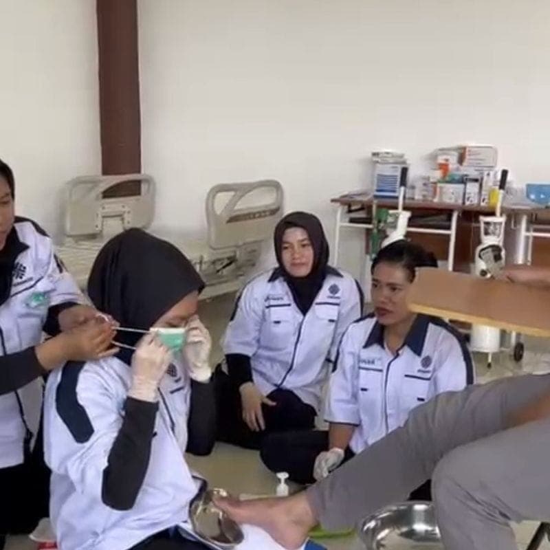 Trainee caregivers practising foot care
