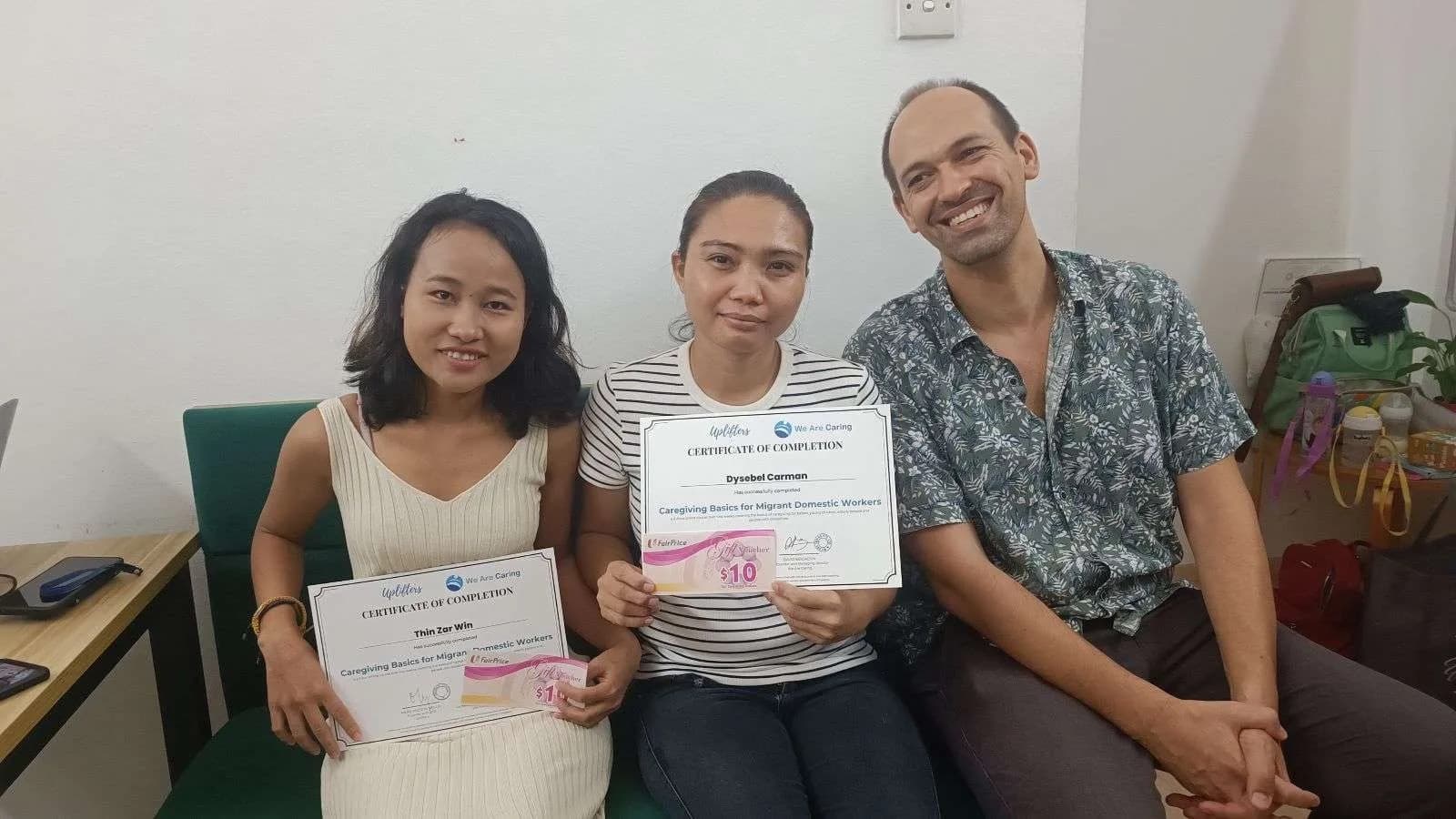 David Bensadon with two helpers holding their training certificates