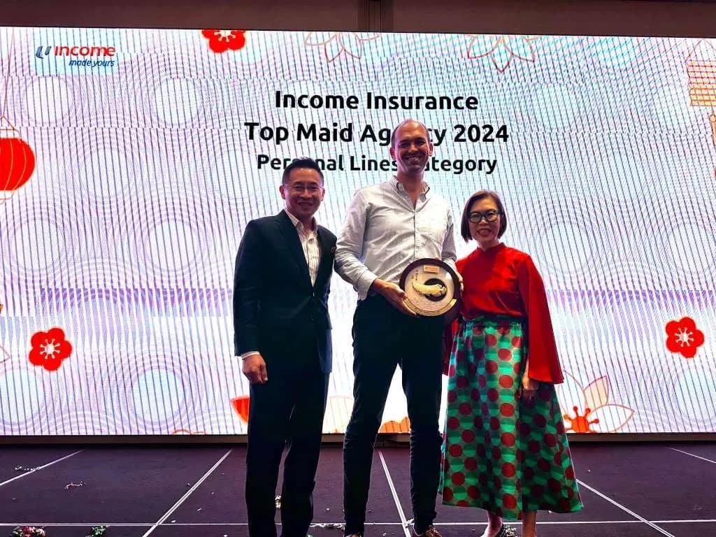 David Bensadon on stage receiving the Income Insurance Top Maid Agency award, 2024