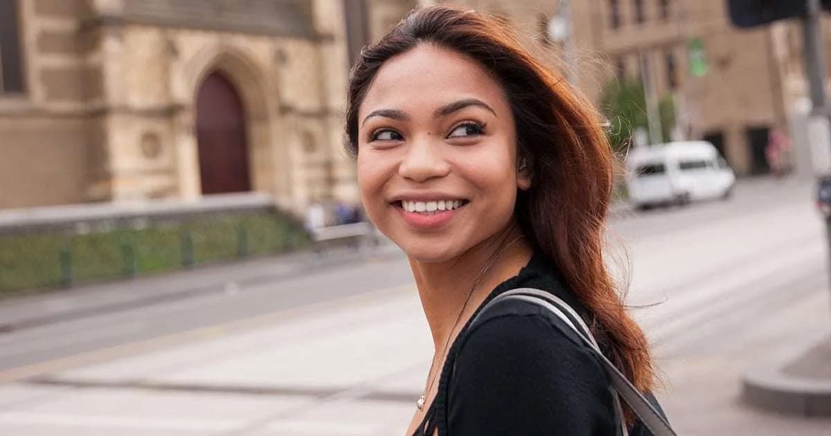 A smiling woman in a city street